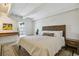 Serene bedroom boasts a decorative headboard, vintage rug, and beamed ceilings at 1255 N Ogden St # 605, Denver, CO 80218