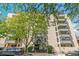 Street view showcasing building entrance and mature trees surrounding the property at 1255 N Ogden St # 605, Denver, CO 80218