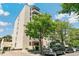 Attractive exterior view of the building, framed by lush green trees and with parking available at 1255 N Ogden St # 605, Denver, CO 80218