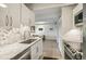 Bright kitchen features white cabinets, granite counters, and stainless-steel appliances at 1255 N Ogden St # 605, Denver, CO 80218