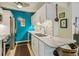 Well-equipped kitchenette with a vibrant blue accent wall, stainless steel appliances, and granite countertops at 1255 N Ogden St # 605, Denver, CO 80218