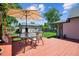 Backyard featuring a red wood deck with an umbrella, a lush green lawn, and a storage shed at 2311 W 46Th Ave, Denver, CO 80211