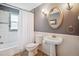 Bathroom with tile floors, grey walls, a pedestal sink, and a shower/tub with a white shower curtain at 2311 W 46Th Ave, Denver, CO 80211