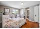 Bedroom with hardwood floors, a floral patterned bedspread, a large window, and a built-in bookcase at 2311 W 46Th Ave, Denver, CO 80211