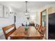 Traditional dining room with wood table, pendant lighting, and adjacent kitchen access at 2311 W 46Th Ave, Denver, CO 80211