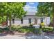 Charming single-story home with a well-maintained lawn, flower beds, and lovely curb appeal at 2311 W 46Th Ave, Denver, CO 80211