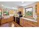 Bright kitchen featuring wood cabinets, black appliances, large windows, and ample countertop space at 2311 W 46Th Ave, Denver, CO 80211
