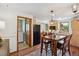 Open-concept kitchen with a dining area, wood cabinets, black appliances, and access to a laundry room at 2311 W 46Th Ave, Denver, CO 80211