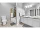 Bright bathroom with a shower-tub combo, neutral tile, and ample vanity space at 17442 Nature Walk Trl # 105, Parker, CO 80134