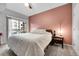 Cozy bedroom with a large bed, nightstand, and access to a balcony with natural light at 17442 Nature Walk Trl # 105, Parker, CO 80134