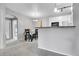 Dining area with table and chairs, open to the kitchen and hallway, with natural light at 17442 Nature Walk Trl # 105, Parker, CO 80134