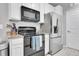 Modern kitchen featuring stainless steel appliances, granite countertops, and white cabinetry at 17442 Nature Walk Trl # 105, Parker, CO 80134