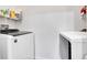 Efficient laundry room with modern washer and dryer units and shelving for storage at 17442 Nature Walk Trl # 105, Parker, CO 80134