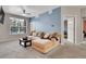 Comfortable living room with neutral carpet, a large sectional sofa, and a bright window at 17442 Nature Walk Trl # 105, Parker, CO 80134