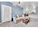 Living room featuring a neutral sectional sofa, view into dining area, and patio door at 17442 Nature Walk Trl # 105, Parker, CO 80134