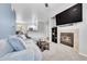Open-concept living room with fireplace and a view of the dining area and kitchen at 17442 Nature Walk Trl # 105, Parker, CO 80134