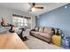 Comfortable living space perfect for exercise with a sofa, stationary bike, and a large window at 17442 Nature Walk Trl # 105, Parker, CO 80134