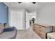 A well-lit living space with a large closet, dresser, and view of the kitchen through the doorway at 17442 Nature Walk Trl # 105, Parker, CO 80134