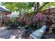 Backyard with stone patio, dining set, seating area, and climbing roses at 669 S Washington St, Denver, CO 80209