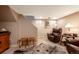 Basement room with a cozy leather armchair, a faux animal skin rug, and neutral tones, offering a comfortable space at 669 S Washington St, Denver, CO 80209