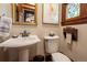 Well-lit bathroom with a pedestal sink, a classic towel holder, and traditional fixtures, creating a vintage feel at 669 S Washington St, Denver, CO 80209