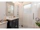 Elegant bathroom featuring subway tile, a glass shower, herringbone tile floors, and a modern sink at 669 S Washington St, Denver, CO 80209