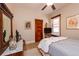 Cozy bedroom featuring hardwood floors, a comfortable bed, natural light, and classic decor with a wooden door at 669 S Washington St, Denver, CO 80209