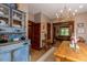 Spacious dining room featuring hardwood floors, stylish chandelier, and display cabinet at 669 S Washington St, Denver, CO 80209