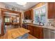 Bright kitchen featuring wood cabinets, stainless steel appliances, marble countertops, and a view into the dining and living spaces at 669 S Washington St, Denver, CO 80209