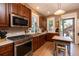 Well-lit kitchen showcasing wood cabinets, stainless steel appliances, an oven, and a doorway leading outside at 669 S Washington St, Denver, CO 80209