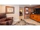 Living room with exposed brick, wooden furniture, and view into office at 669 S Washington St, Denver, CO 80209