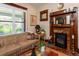 Bright living room featuring a decorative fireplace, hardwood floors, and large windows at 669 S Washington St, Denver, CO 80209