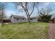 The home features a lawn, a mature shade tree, storage shed, and backyard privacy fence at 6895 W Oregon Dr, Lakewood, CO 80232
