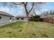 Spacious backyard featuring a well-maintained lawn, fence, and detached garage at 6895 W Oregon Dr, Lakewood, CO 80232