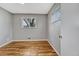 Bedroom featuring hardwood floors, neutral paint, and a window providing natural light at 6895 W Oregon Dr, Lakewood, CO 80232