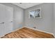 Bedroom with hardwood floors, neutral walls, closet, and a sunny window at 6895 W Oregon Dr, Lakewood, CO 80232