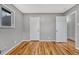 Spacious bedroom with hardwood floors, gray paint and a large window at 6895 W Oregon Dr, Lakewood, CO 80232
