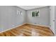 Cozy bedroom with hardwood floors and two windows offering natural light at 6895 W Oregon Dr, Lakewood, CO 80232