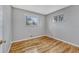 Bedroom showcasing hardwood floors, a window overlooking outside, and neutral wall color at 6895 W Oregon Dr, Lakewood, CO 80232