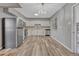 Bright kitchen featuring stainless steel appliances, modern lighting, and wood-look floors at 6895 W Oregon Dr, Lakewood, CO 80232