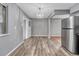 Bright kitchen with laminate floors and a chandelier fixture at 6895 W Oregon Dr, Lakewood, CO 80232