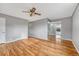Sun-filled living room showcasing gleaming hardwood floors and a ceiling fan at 6895 W Oregon Dr, Lakewood, CO 80232