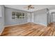 Bright living room featuring hardwood floors, neutral paint, large windows, and ceiling fan at 6895 W Oregon Dr, Lakewood, CO 80232