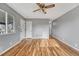 Bright living room with hardwood floors, neutral paint, two closets, and views of the front yard at 6895 W Oregon Dr, Lakewood, CO 80232