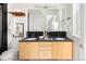 Modern bathroom features a double sink vanity, decorative mirror and contrasting dark tile accents at 340 S Lafayette St # 201, Denver, CO 80209
