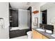 Updated bathroom boasts a shower over tub with glass doors and modern fixtures at 340 S Lafayette St # 201, Denver, CO 80209