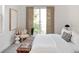 Bright bedroom featuring a sliding door to a balcony and contemporary furnishings at 340 S Lafayette St # 201, Denver, CO 80209