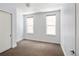 Bright bedroom featuring neutral carpet, two windows, and a closet at 340 S Lafayette St # 201, Denver, CO 80209
