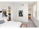 Cozy bedroom with a view to kitchen and bathroom, featuring large windows and artistic decor at 340 S Lafayette St # 201, Denver, CO 80209