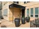 Building entrance with awning, planters, and access for the building residents at 340 S Lafayette St # 201, Denver, CO 80209
